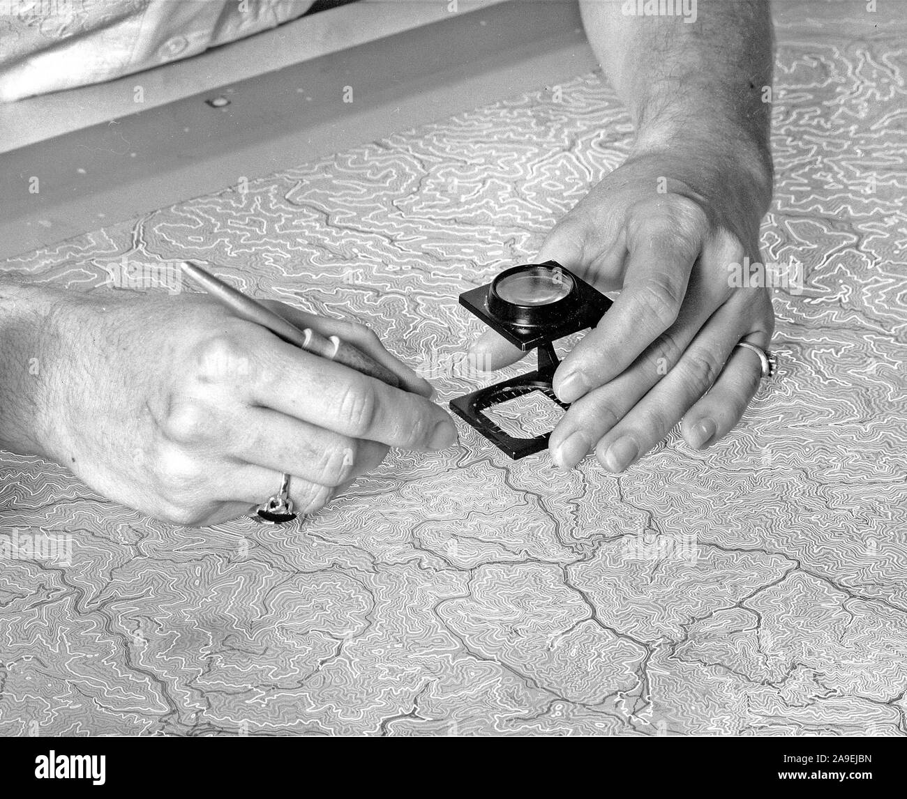 1957 - Color separation scribing of the intermediate contours for a USGS topographic map using a freehand scriber. Stock Photo
