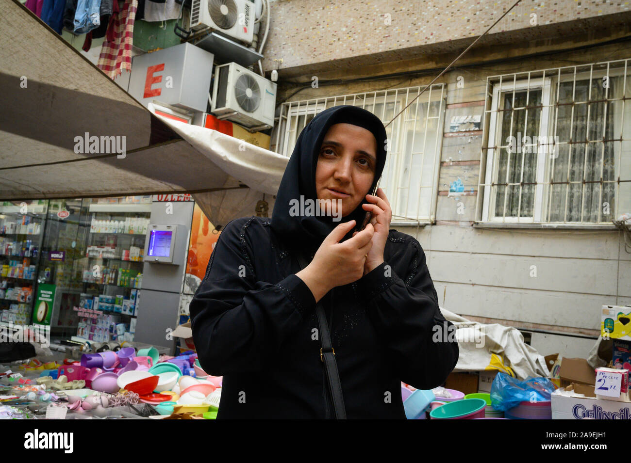 Muslim woman on her mobile phone at the Monday Market, Istanbul, Turkey Stock Photo