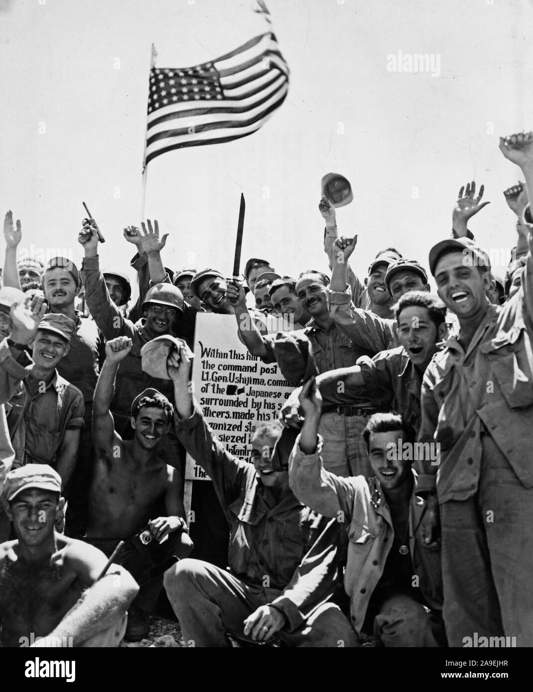 1st Div Marines and 7th Div Soldiers cheer a victory atop hill number 89 --thus ending the battle of Okinawa - Stock Photo