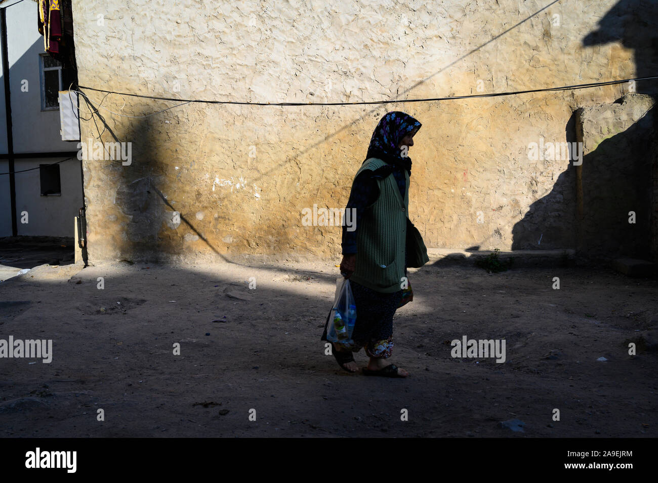 Muslim woman walking in the shadows, Istanbul, Turkey Stock Photo