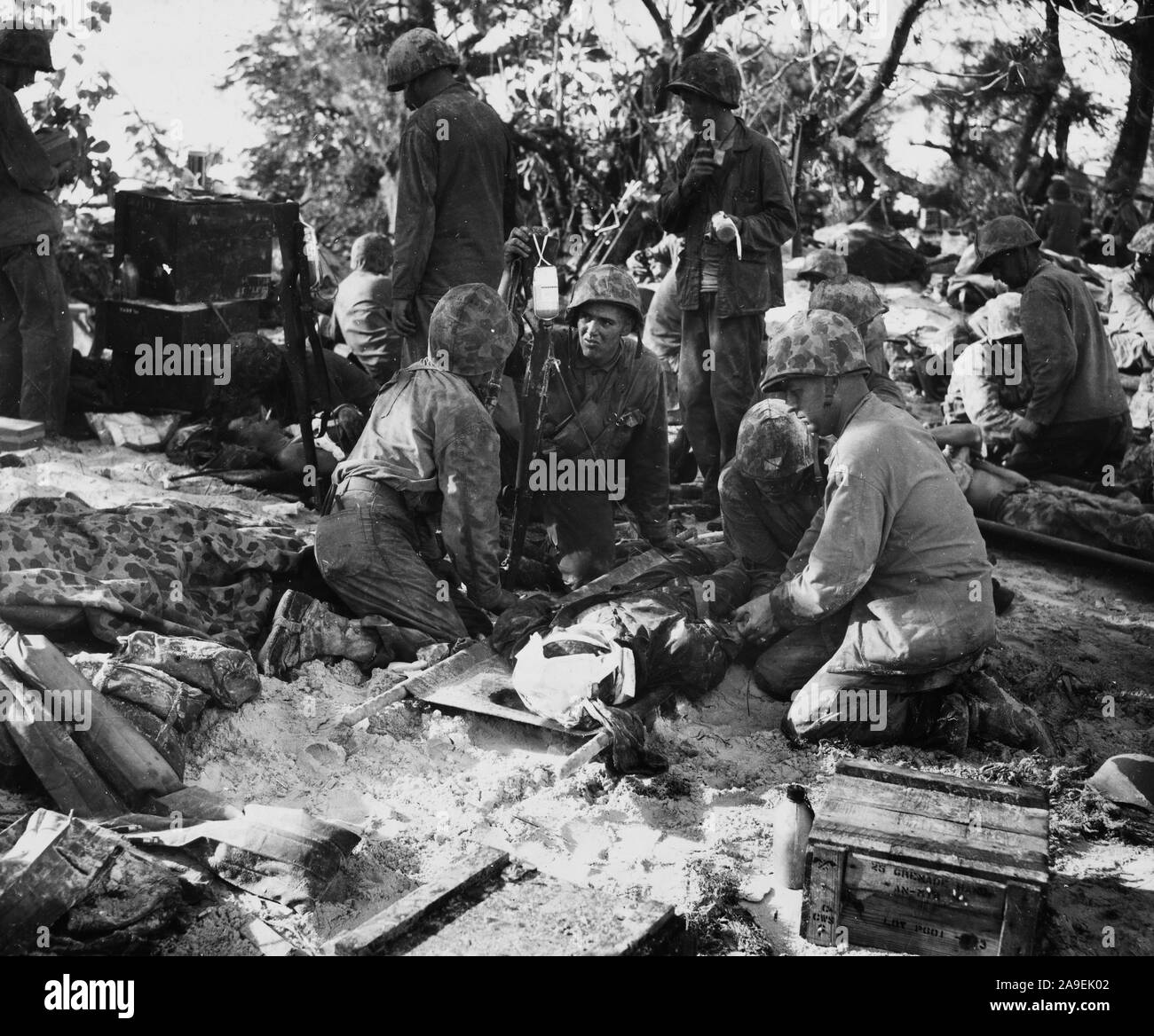Wounded marine on Saipan receives blood plasma given by a civilialn back  home in the US. Stock Photo