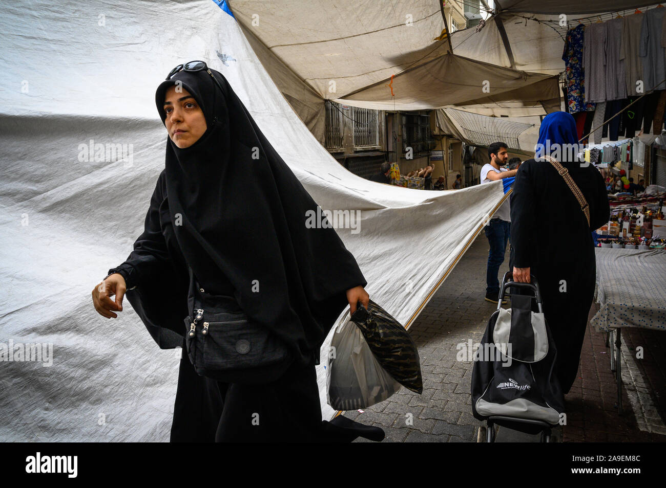 Muslim woman shopping in the Fatih Market, Istanbul, Turkey Stock Photo