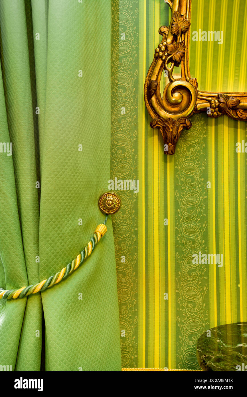 Gold frame on green wallpaper Stock Photo