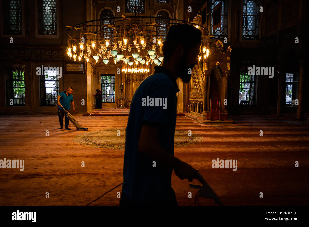 Men vacuuming inside the Eyup Sultan Mosque, Istanbul, Turkey Stock Photo