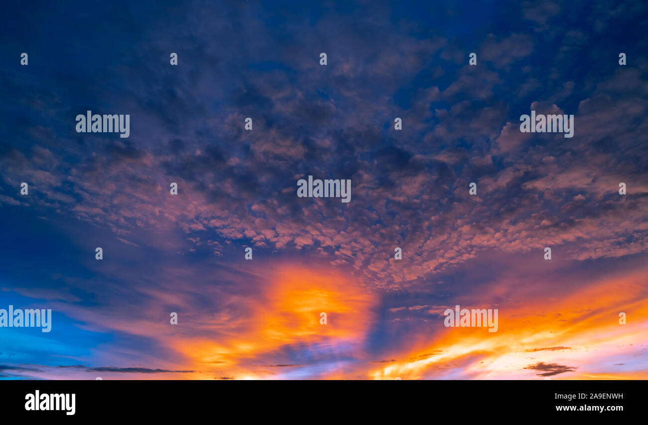 Beautiful sunset sky. Golden and orange sky and clouds with sunbeam ...