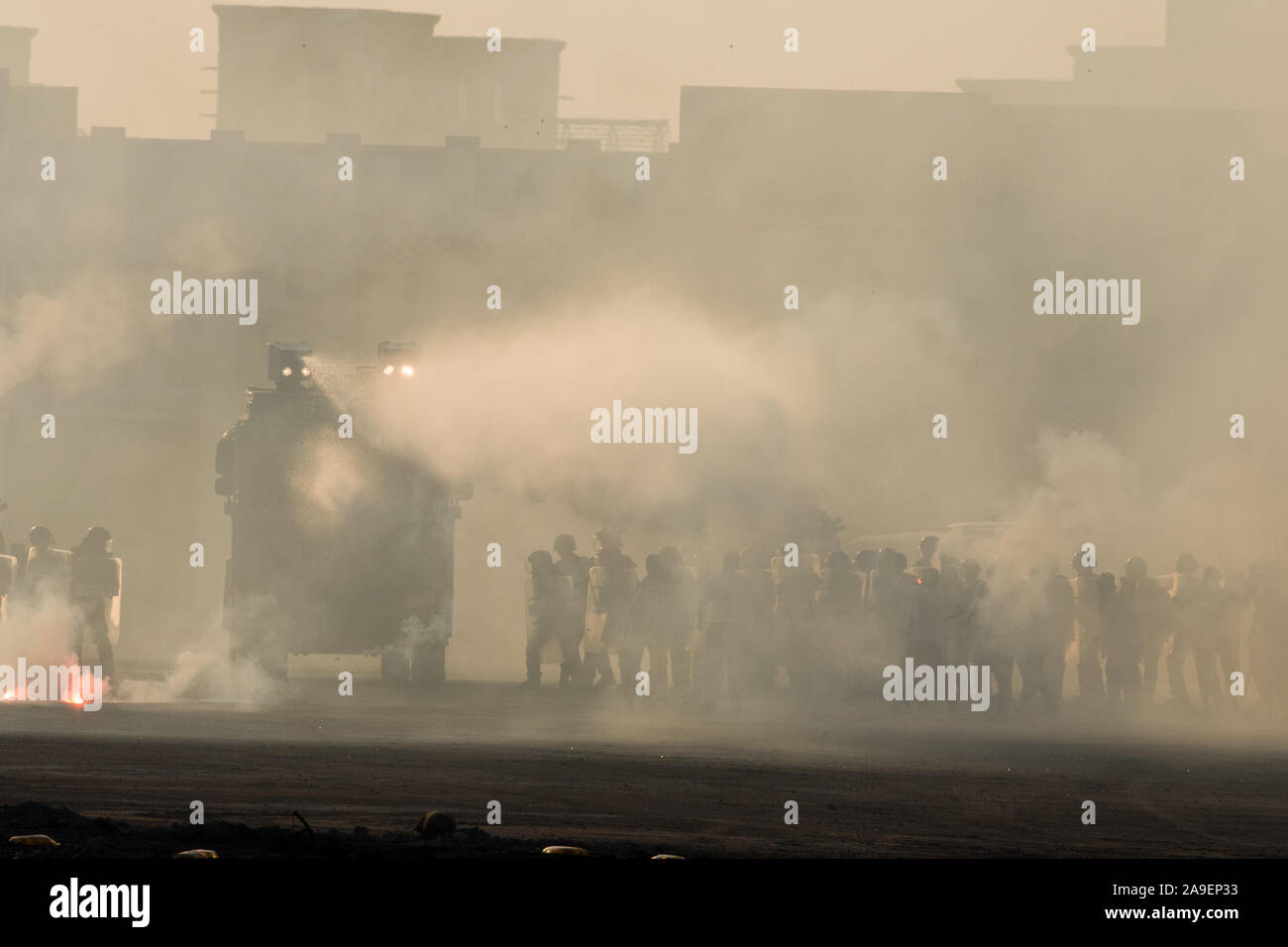 Military police riot response to a protest with tear gas, smoke, fire, explosions. Political expression, riot, protest, demonstration and military Stock Photo