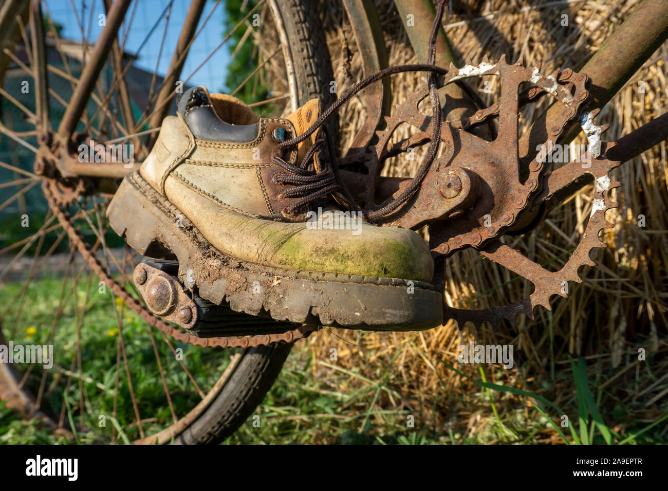 Pair of old worn leather hiking boots on a rusty vintage bicycle outdoors  balanced on the pedals as though riding it Stock Photo - Alamy