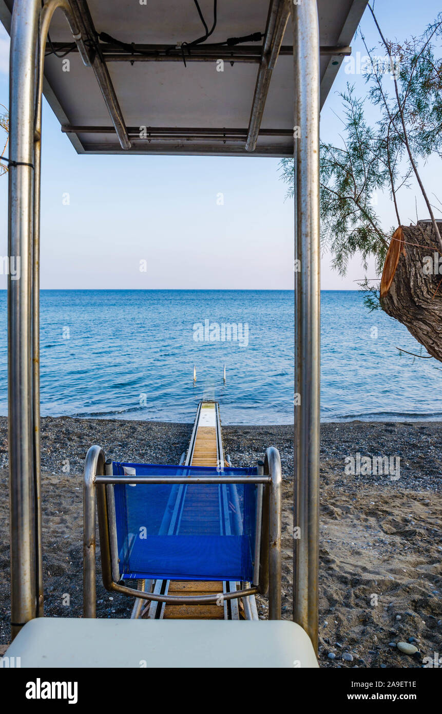 Beach wheel chair system which enables disabled people’s access to the sea without using their standard wheelchair. Stock Photo