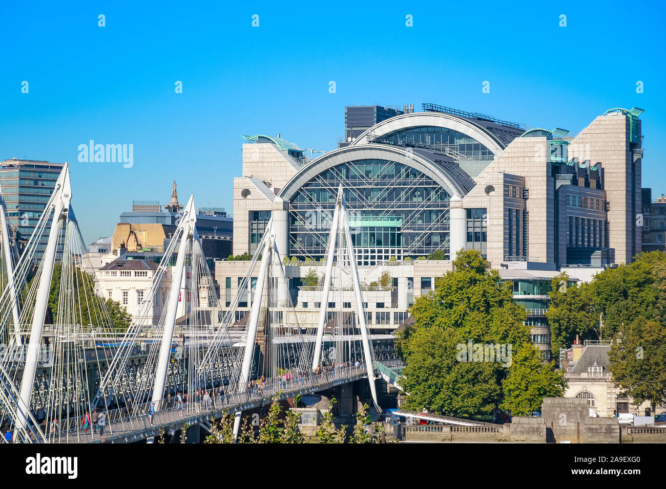London, UK - September 22, 19 - Hungerford Bridge and Golden Jubilee Bridges with the river side of Charing Cross station in the background Stock Photo