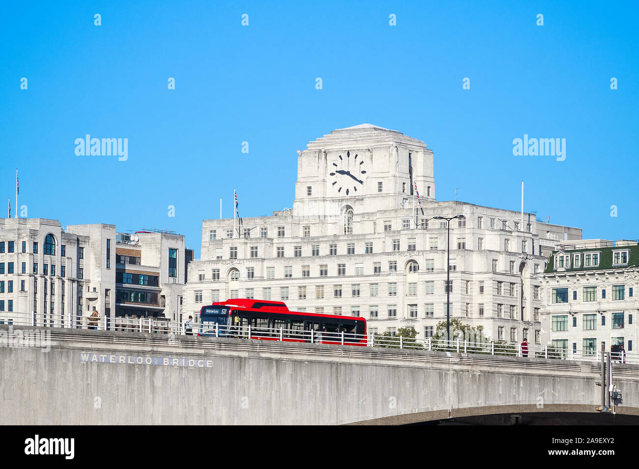 Waterloo Bridge with a passing bus and facade of Shell Mex House in the background in London Stock Photo