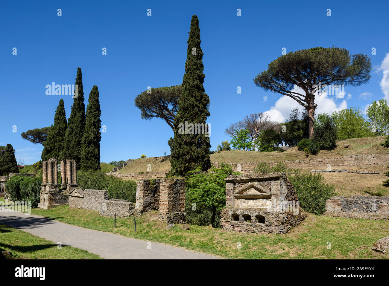 Pompei. Italy. Archaeological site of Pompeii. Necropolis of Porta Nocera (Nuceria Gate) and remains of the defensive walls (cinta muraria) in the bac Stock Photo