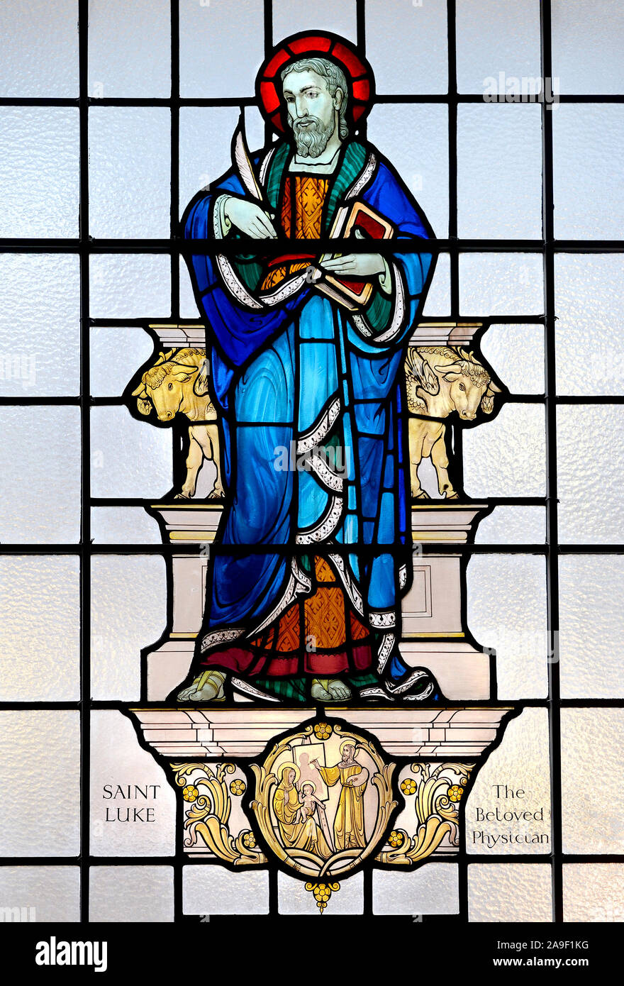 London, UK. St Marylebone Parish Church, Marylebone Road. Stained glass window: St Luke 'The Beloved Physician' Stock Photo