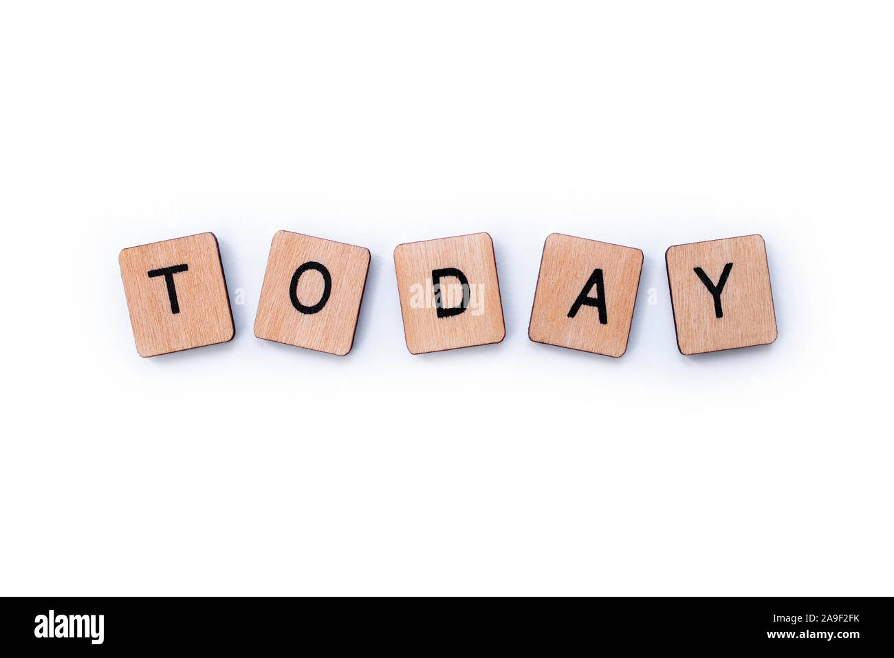 The word TODAY, spelt with wooden letter tiles over a white background. Stock Photo