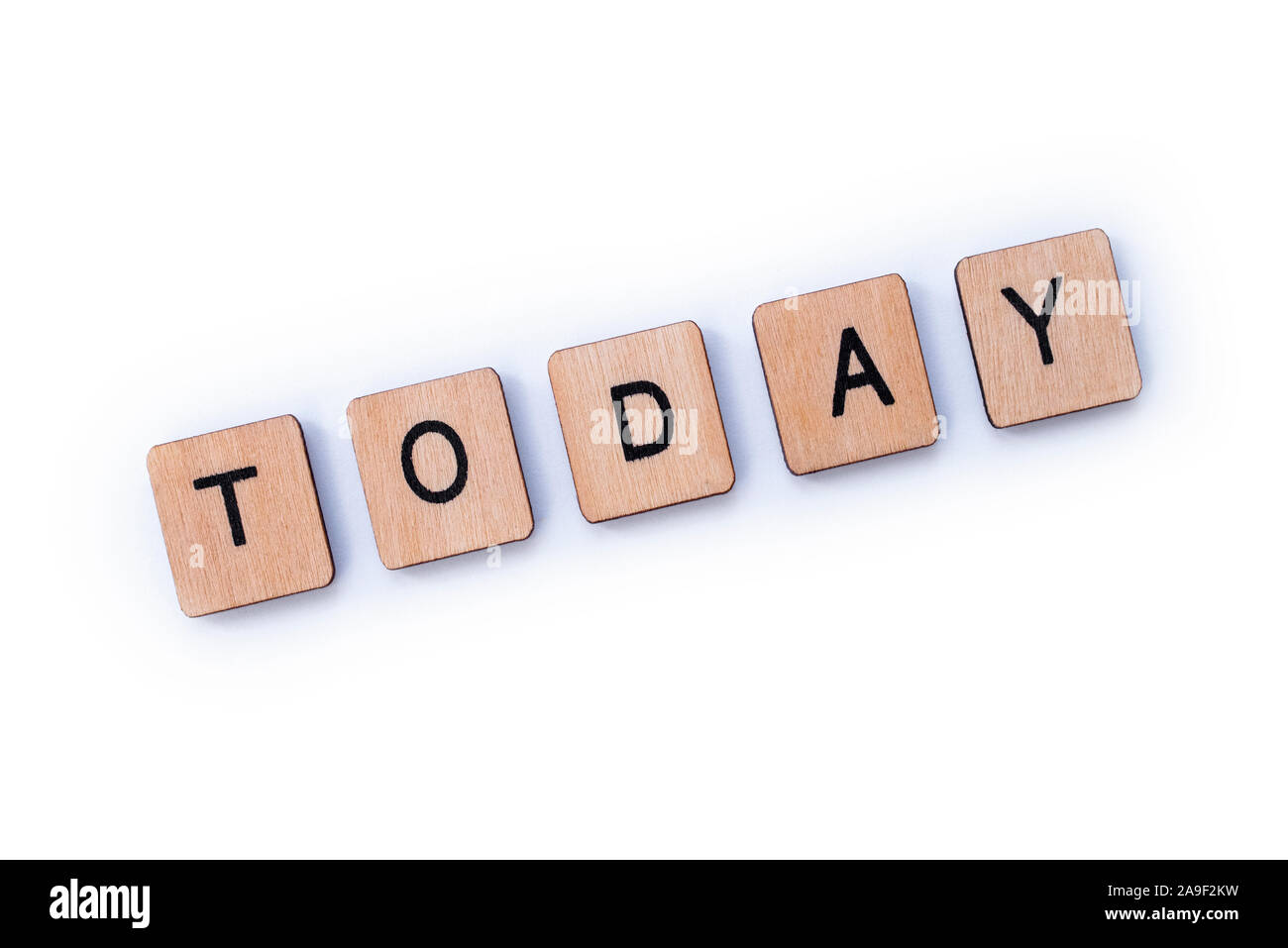 The word TODAY, spelt with wooden letter tiles over a white background. Stock Photo