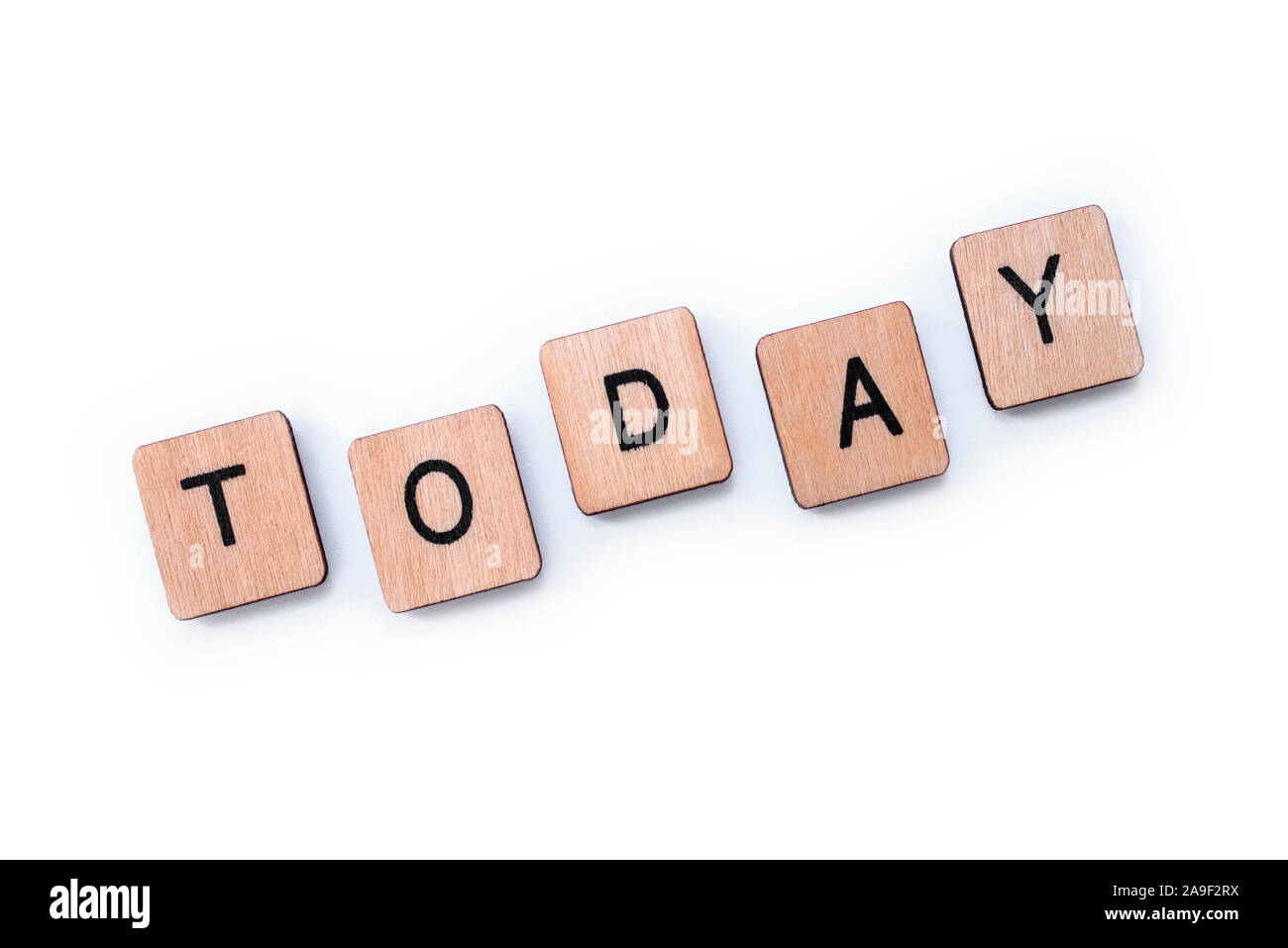 The word TODAY, spelt with wooden letter tiles over a white background. Stock Photo