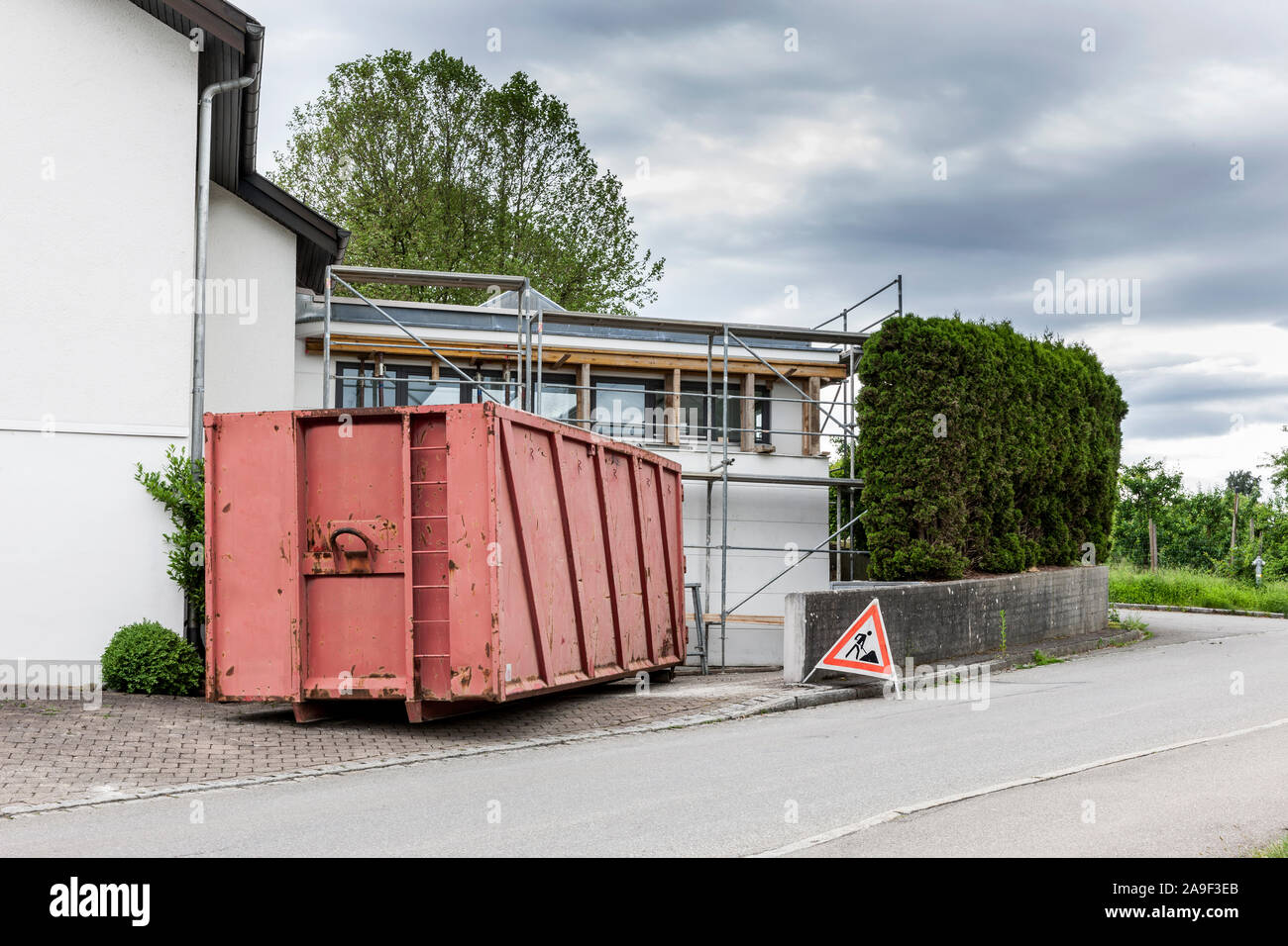Construction container in front of the house Stock Photo