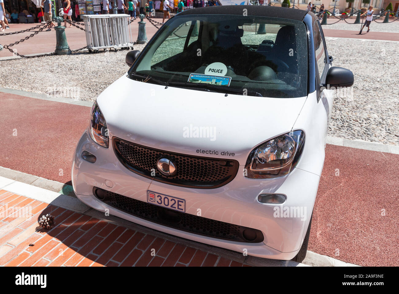 Monte Carlo, Monaco - August 15, 2018: White electric drive Smart car stands on a city square at sunny day, close up photo Stock Photo