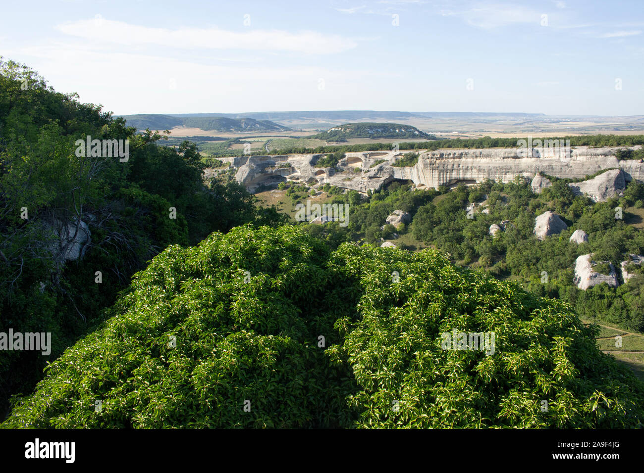 Mountain landscape in the afternoon. Gorge in the highlands. Limestone rocks. Crimean landscape. The beauty of the stone ledges corroded by the wind. Stock Photo