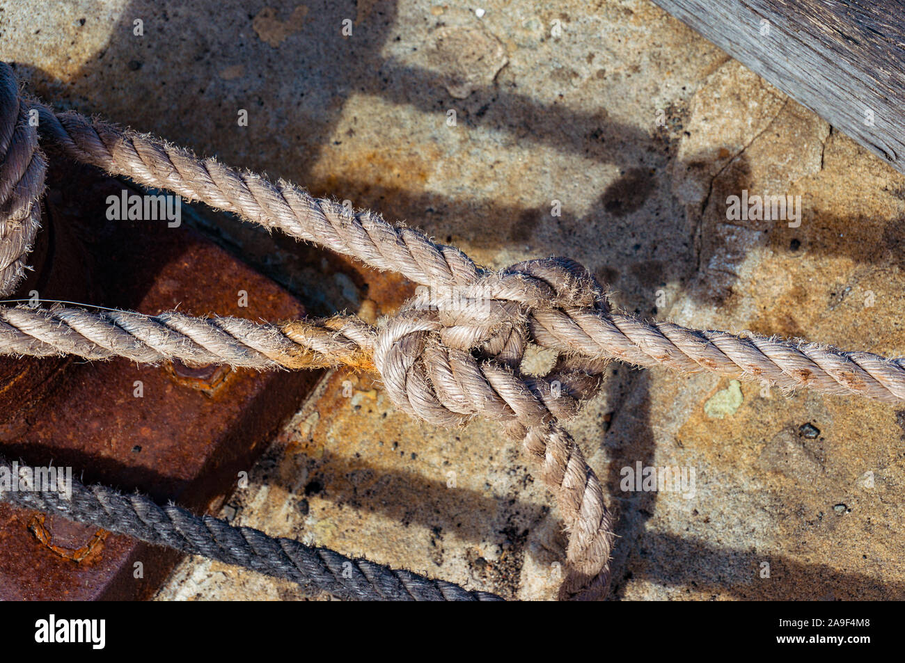 Rope tied in knot. Yacht berthing detail Stock Photo