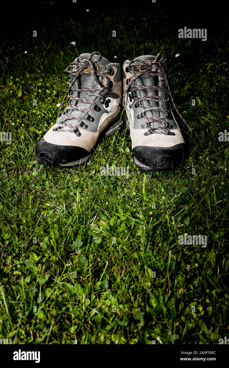 Hiking boots in dark meadow Stock Photo