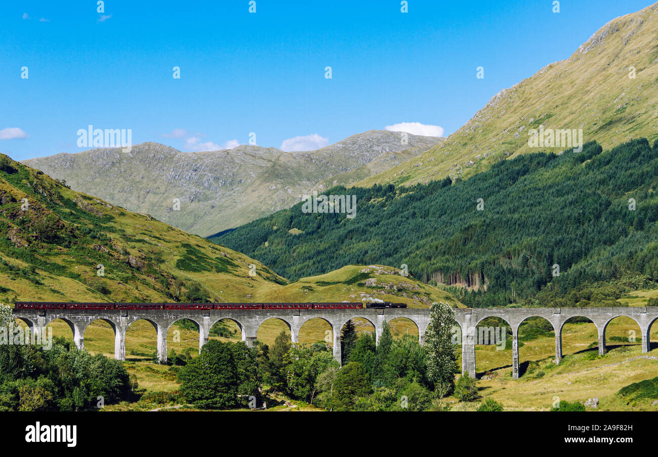 The Jacobite Steam Train, also known as the Hogwarts train as it was used in the Harry Potter movie franchise, traveling along the Glenfinnan Viaduct Stock Photo