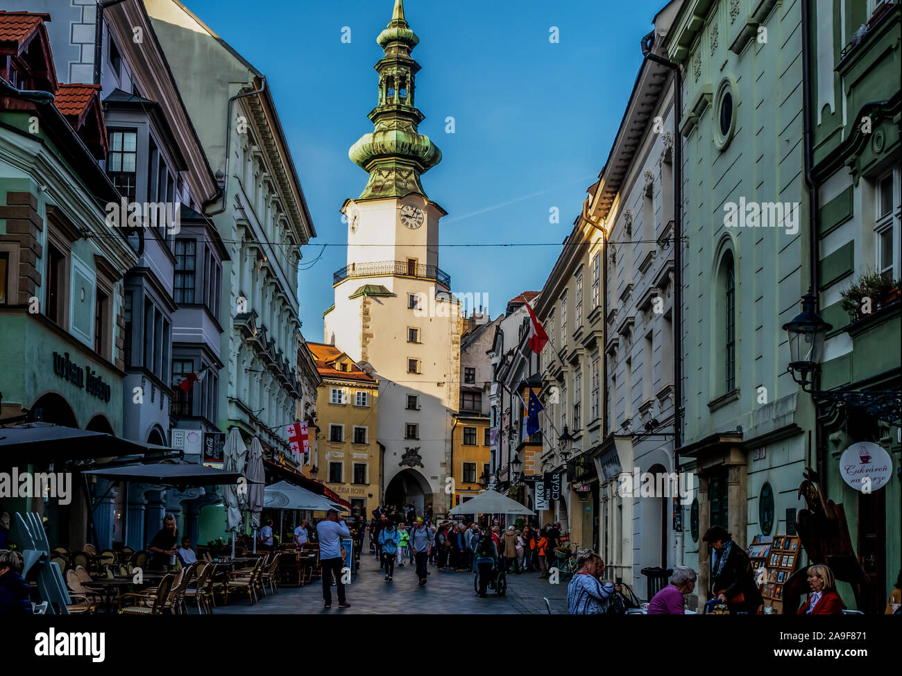 Shopping street leading to the 17th Century Church and Monastery of The Merciful Brothers in Bratislava, Slovakia Stock Photo