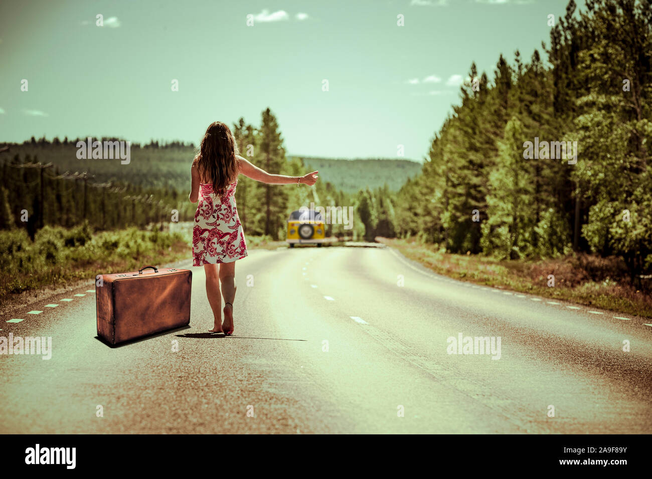 Hitchhiker with suitcase Stock Photo