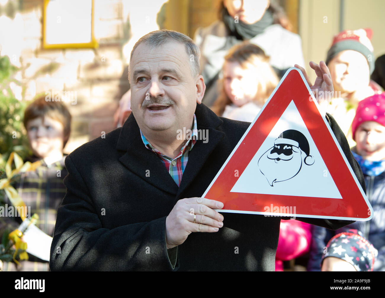 14 November 2019, Brandenburg, Fürstenberg: Lutz Wilke, local ruler in Himmelpfort, with a sign 'Achtung Santa Claus'. Photo: Soeren Stache/dpa-Zentralbild/dpa Stock Photo