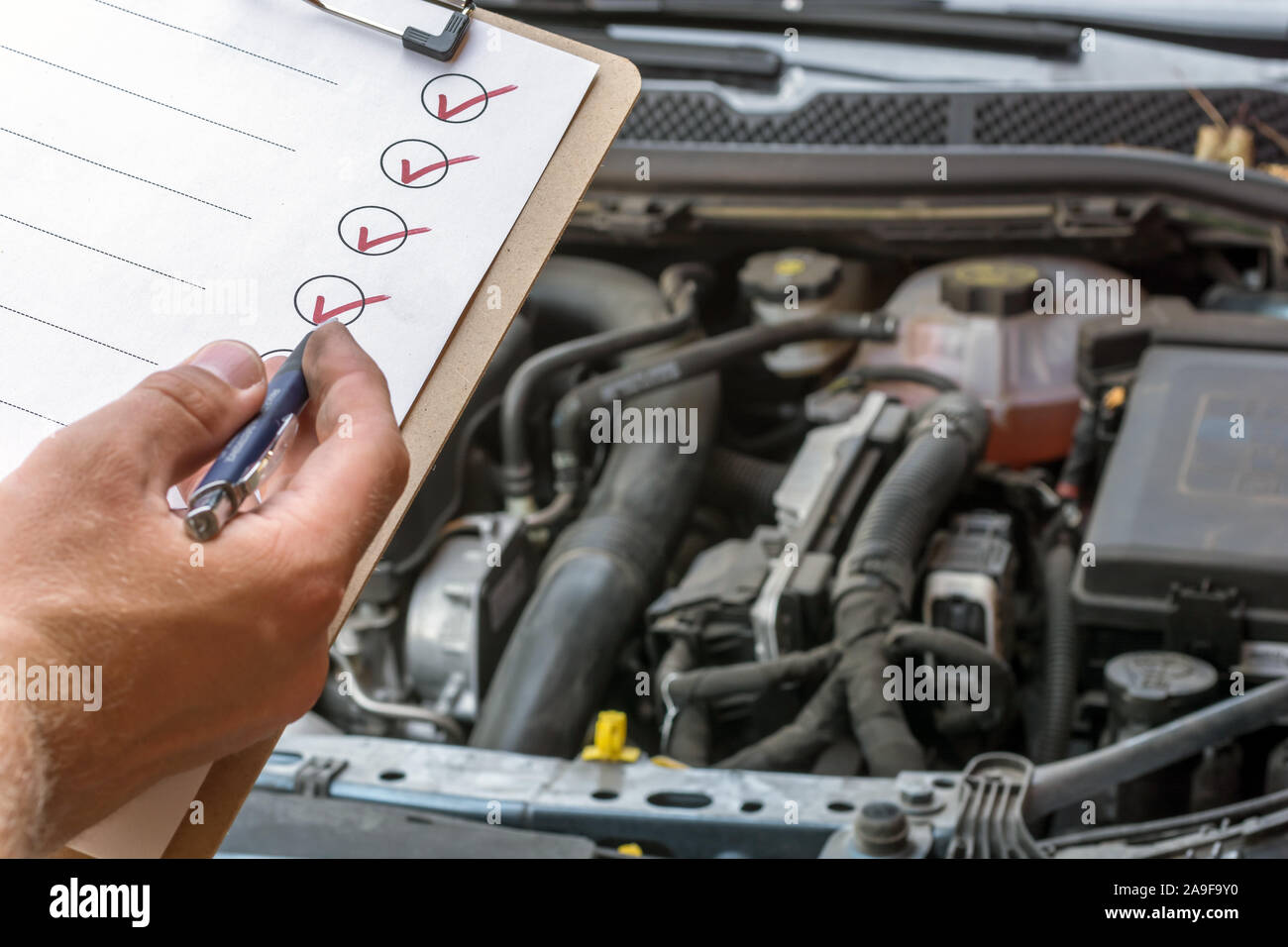 Checking the technical condition of a car with the help of a checked checklist Stock Photo