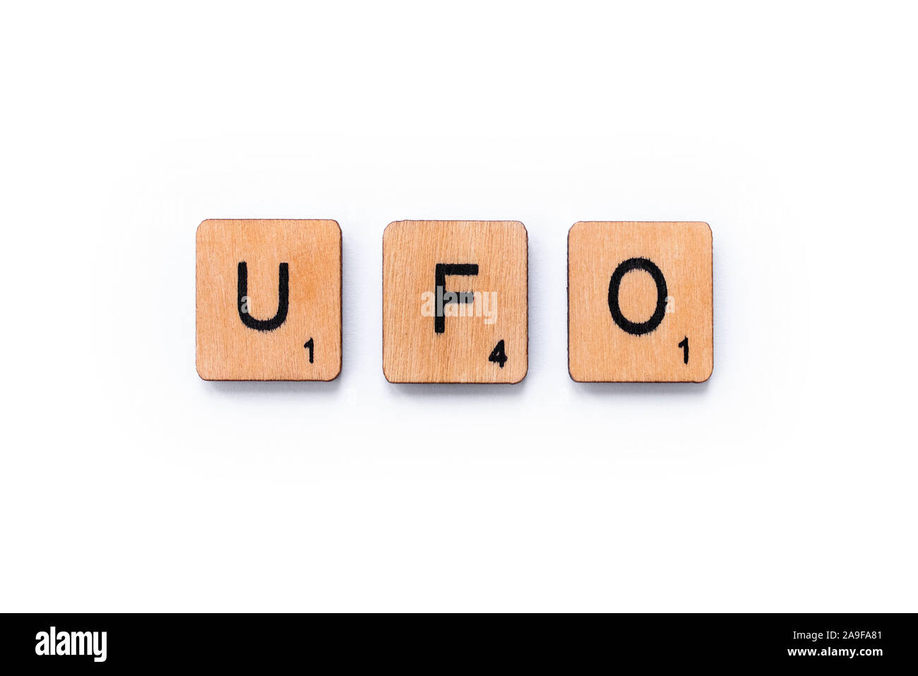 London, UK - June 12th 2019: The abbreviation UFO which stands for Unidentified Flying Object, spelt with wooden letter tiles over a white background. Stock Photo