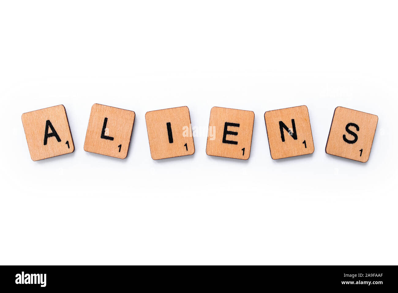 London, UK - June 12th 2019: The word ALIENS, spelt with wooden letter tiles over a white background. Stock Photo