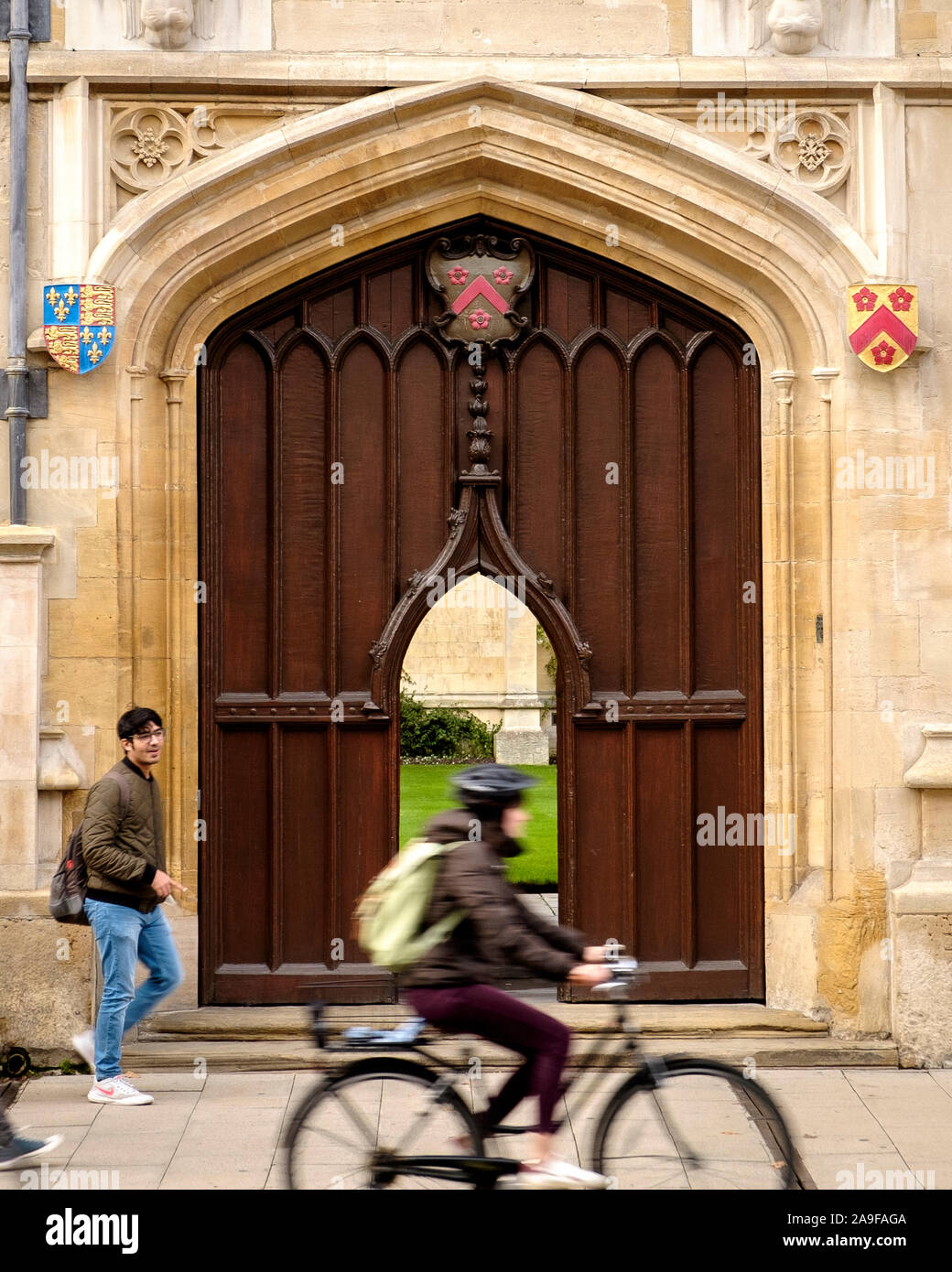 A cyclist as a motion blur cycling past All Souls College, Oxford Stock Photo