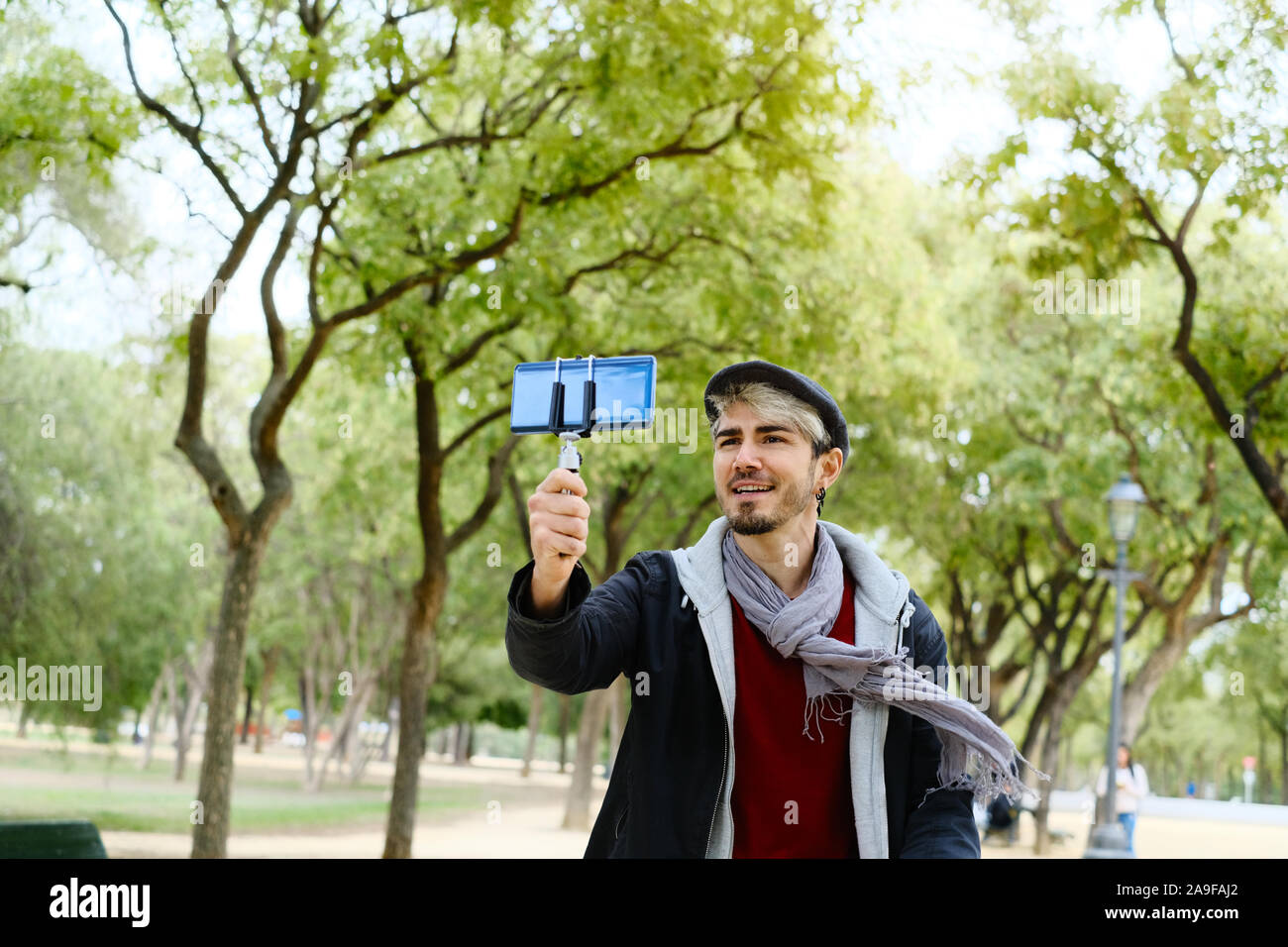 Millennial Man Recording Vlog With Mobile Phone For Social Media Stock Photo