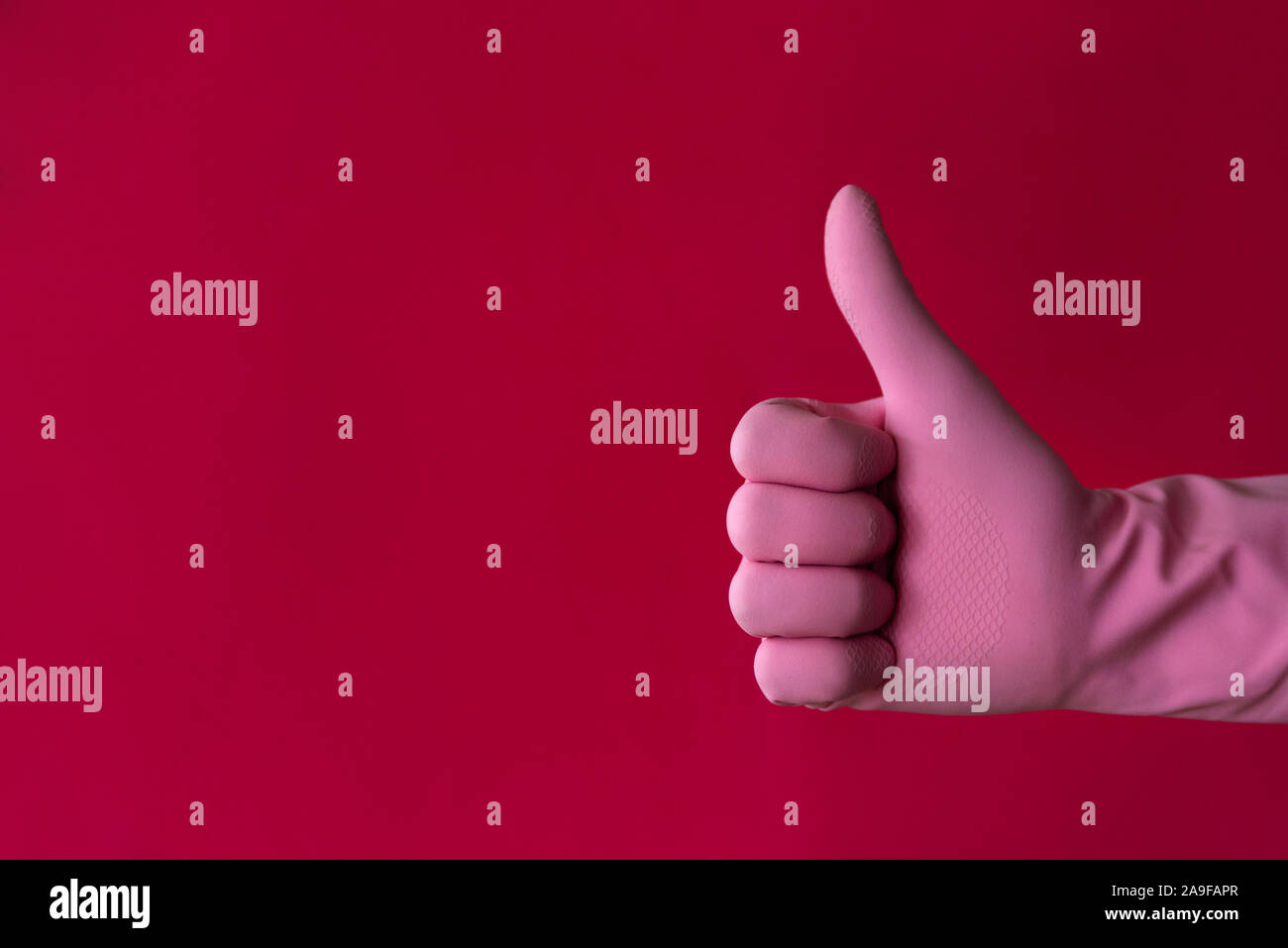 Pink hand thumb-up gesture on red. Left hander day concept Stock Photo ...