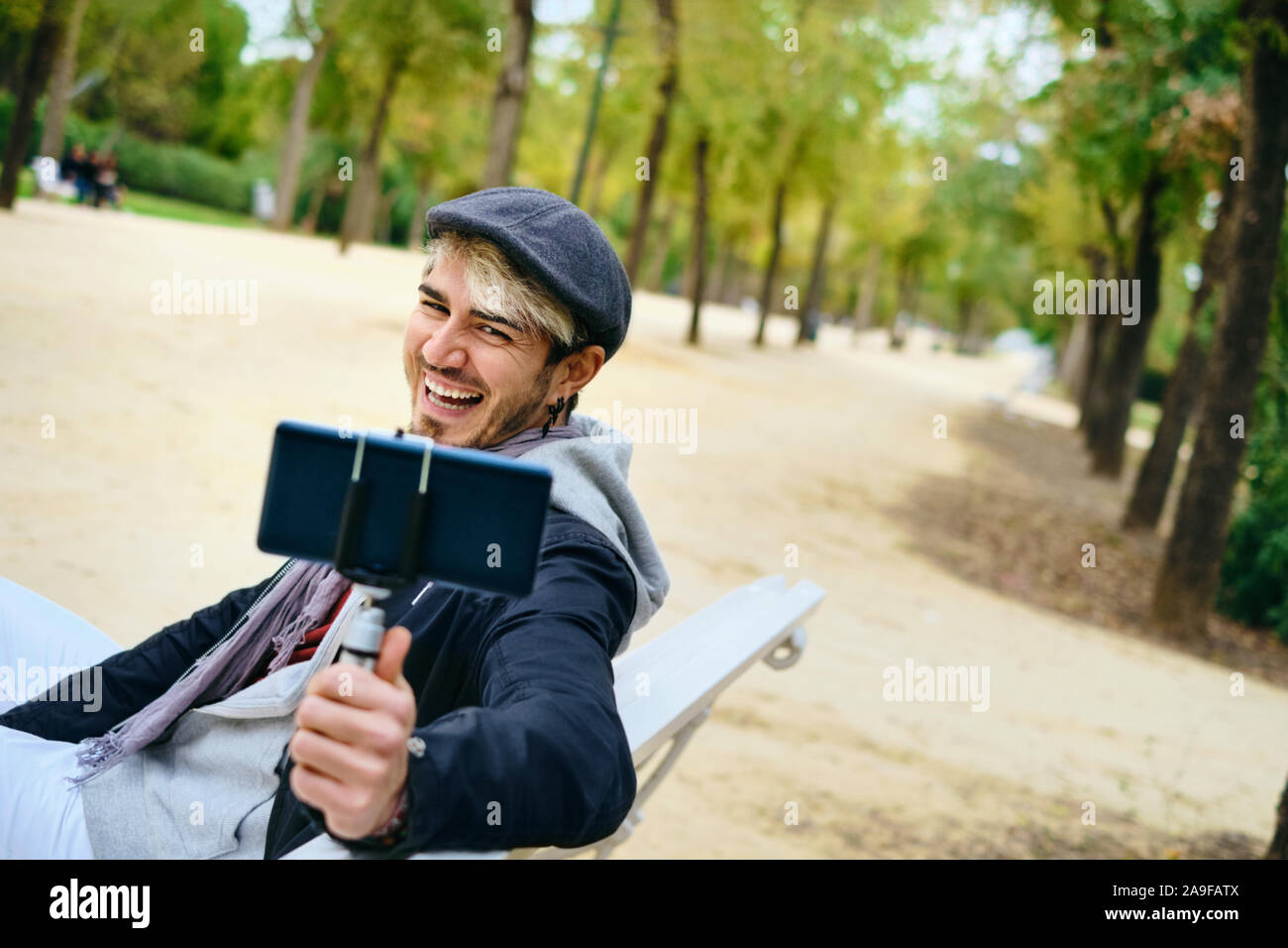 Millennial Man Recording Vlog With Mobile Phone For Social Media Stock Photo