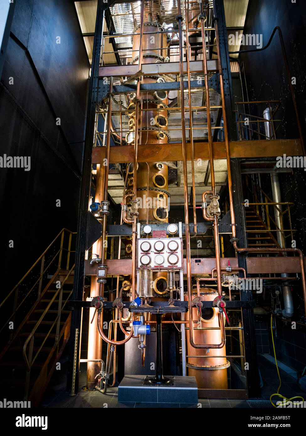Neisson Rhum, rum distillery by steam engine, distillation tower Stock