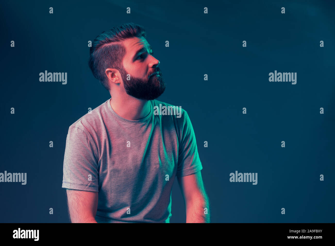 Neon portrait of a young attractive man in the studio. Close-up Stock ...