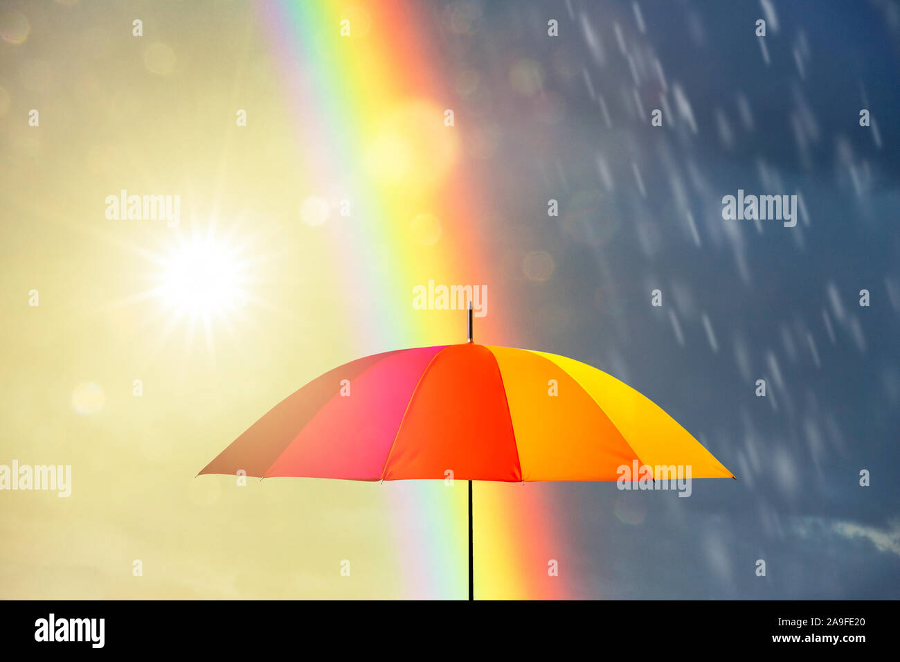 Rainbow with umbrella Stock Photo