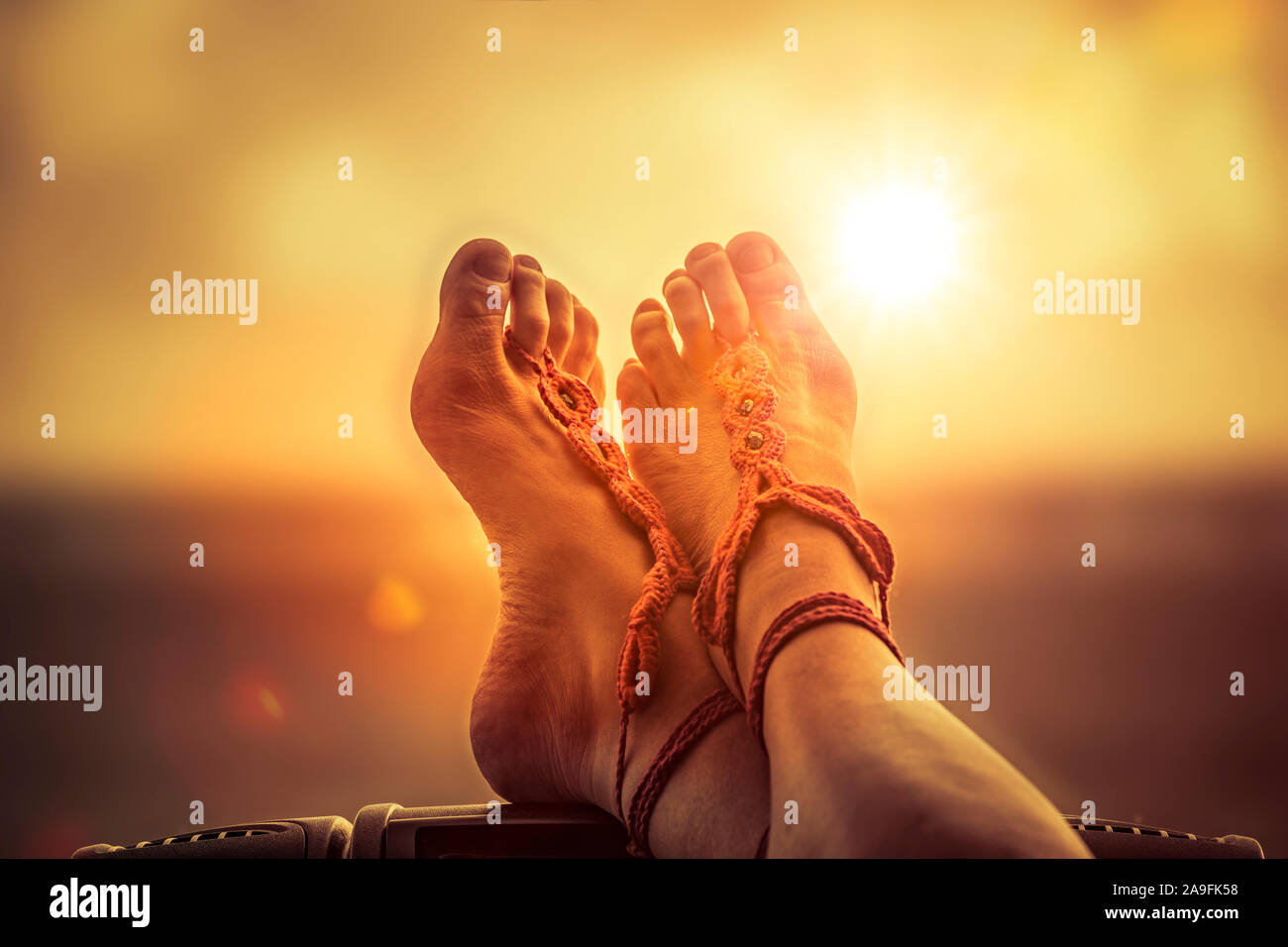 Put your feet up and relax at sunset Stock Photo Alamy
