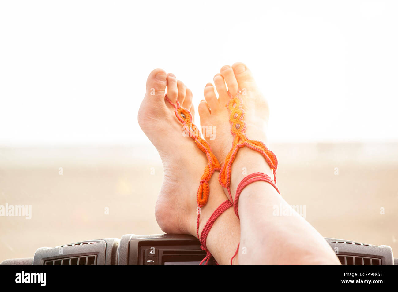Put your feet up and relax in the car on the beach Stock Photo Alamy