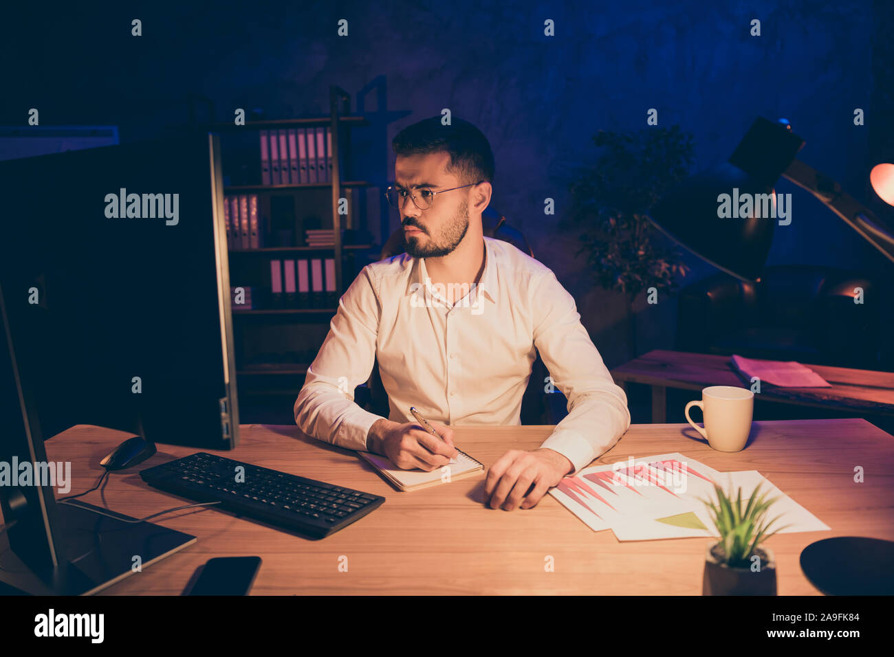 Photo of pensive thoughtful entrepreneur focused on memorizing all needed information noting down most essential aspects of successful work process Stock Photo
