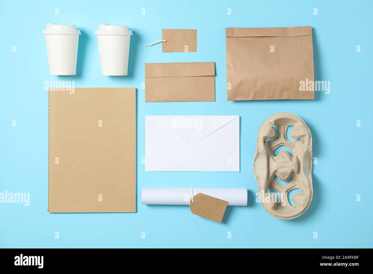 Flat lay. Paper cups and office supplies on blue background, copy space ...