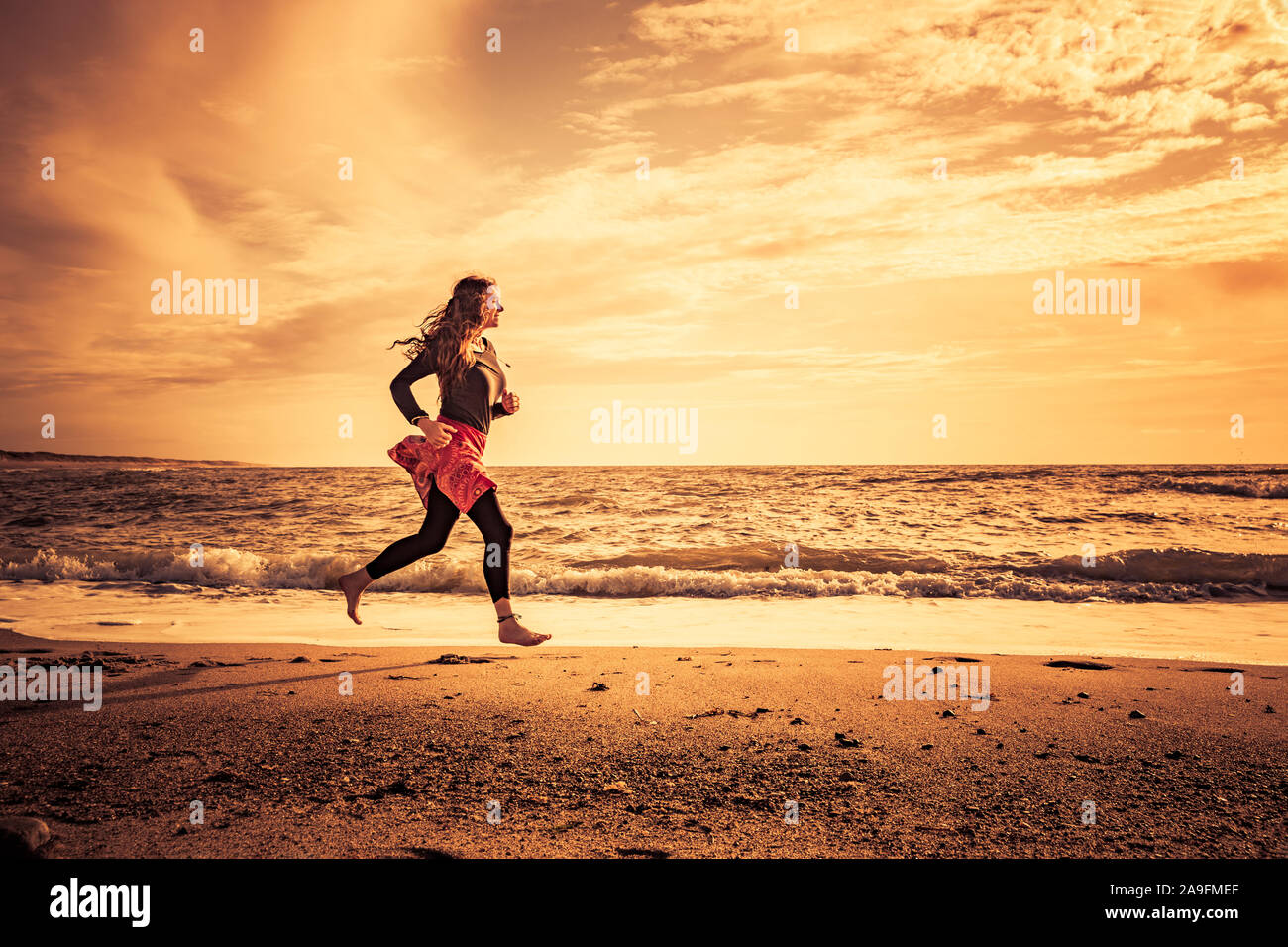 Beach run on the beach at sunset Stock Photo Alamy