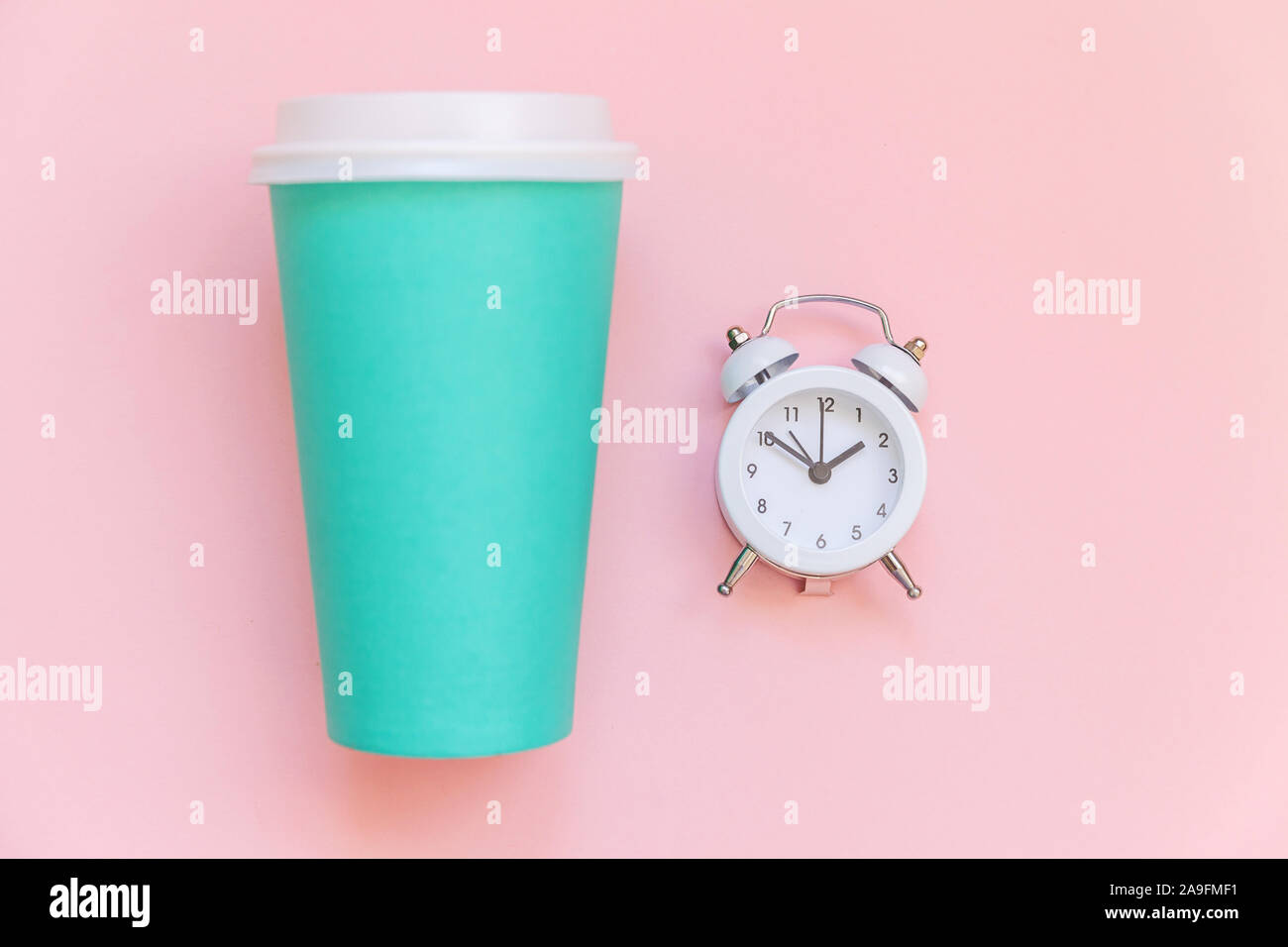 Simply flat lay design blue paper coffee cup and alarm clock isolated ...