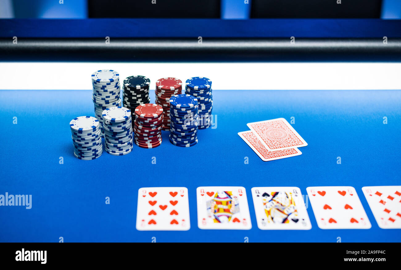 Piles of chips and Texas Hold 'em poker cards on the table at the