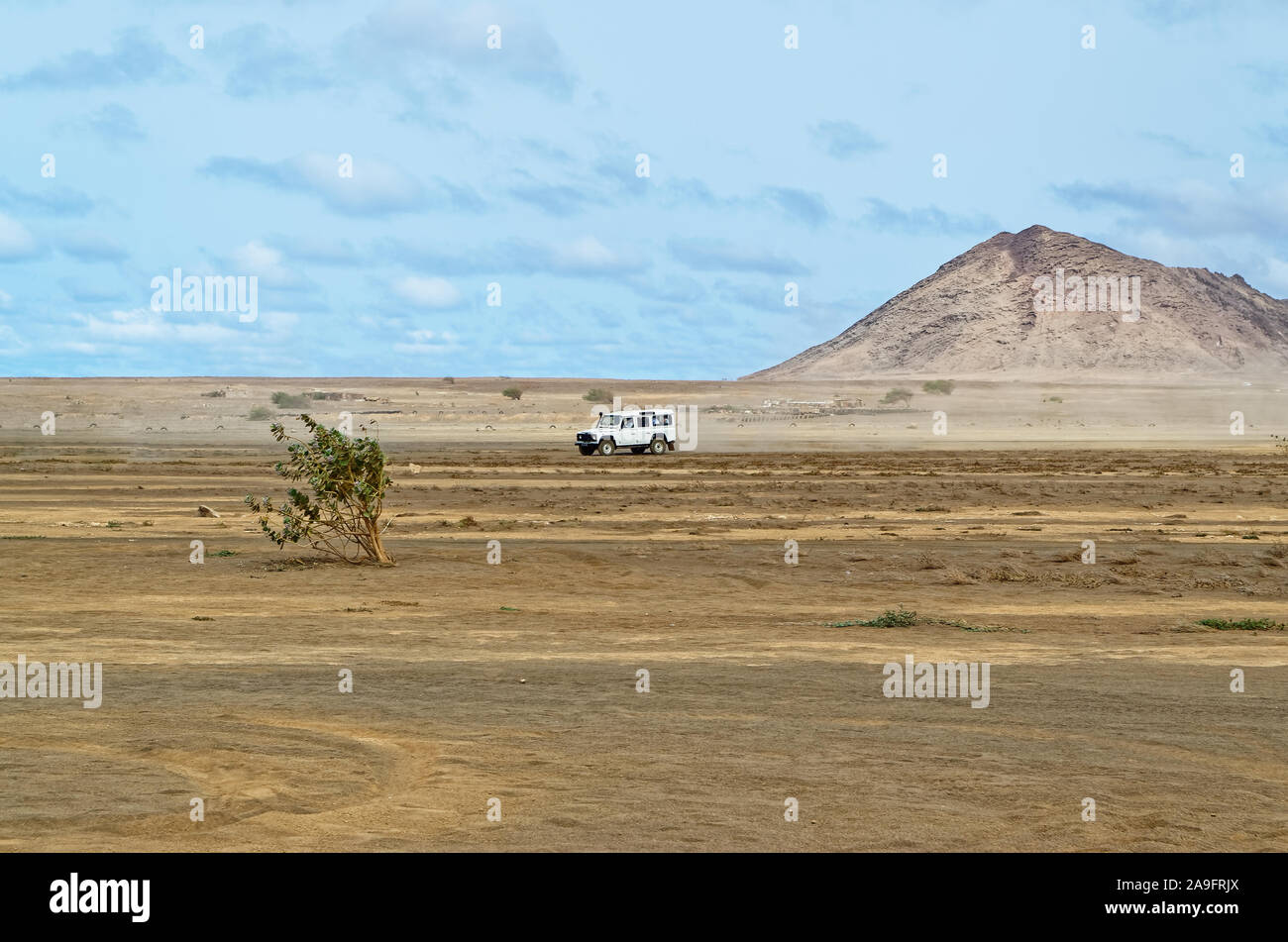 Crossover car driving over the arid landscape near Buracona on the island Sal, Cape Verde Stock Photo