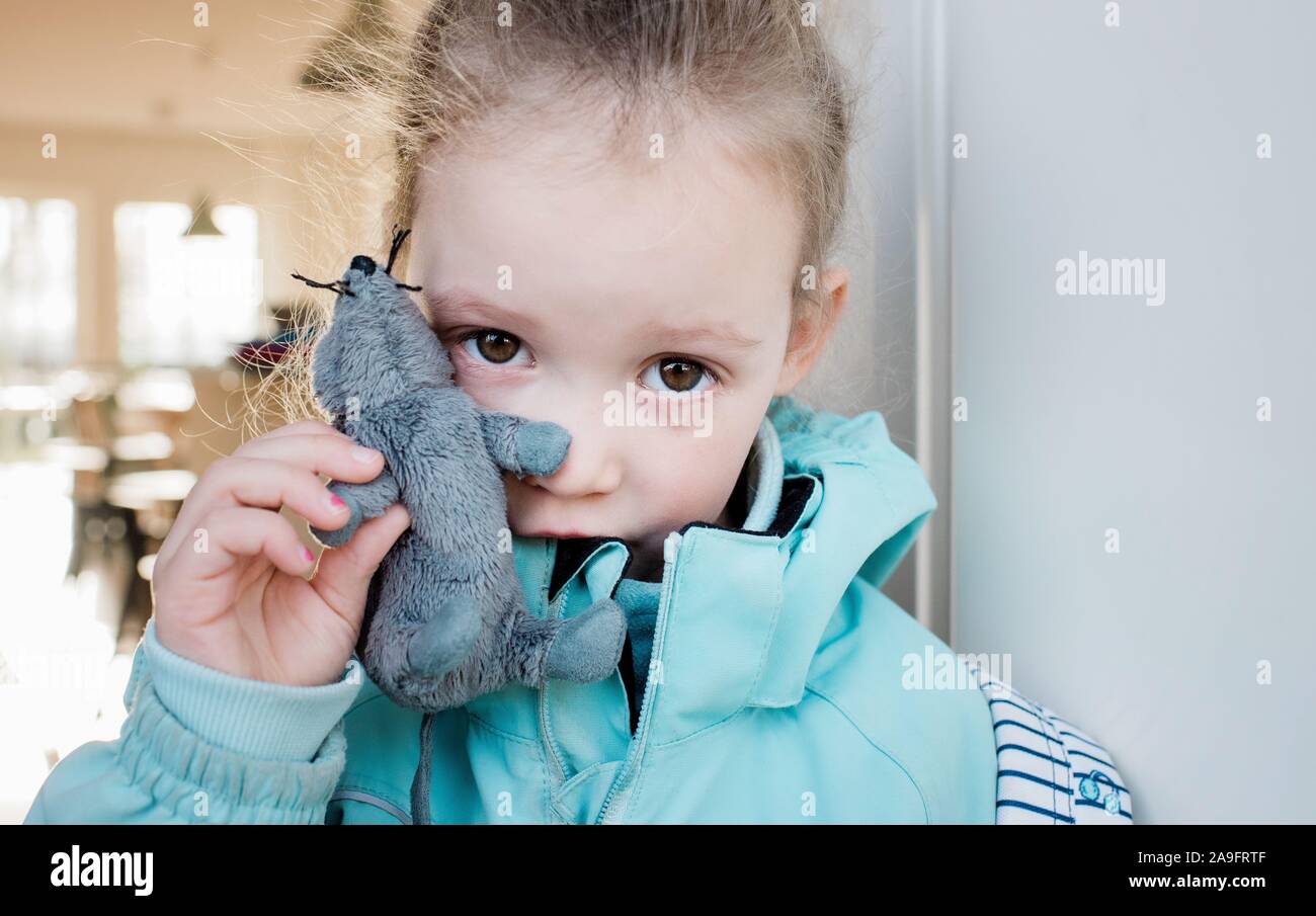 young school girl crying holding her toy looking sad Stock Photo