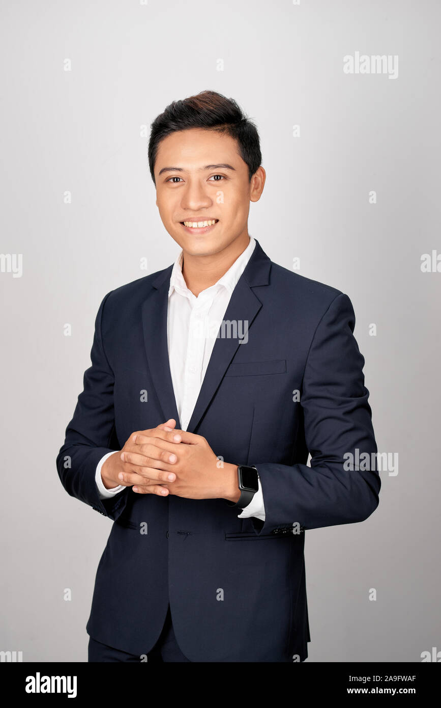 Asian man in office suit posing on white background Stock Photo - Alamy