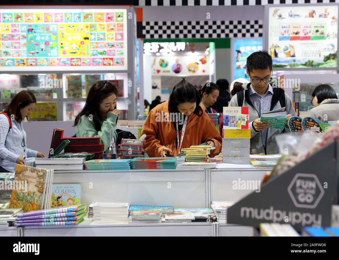 Shanghai, China. 15th Nov, 2019. People select books during the 2019 China Shanghai International Children's Book Fair (CCBF) at Shanghai World Expo Exhibition and Convention Center in Shanghai, east China, Nov. 15, 2019. The 2019 China Shanghai International Children's Book Fair (CCBF) kicked off here on Friday. The three-day event bring together more than 400 exhibitors from over 30 countries and regions, including publishing houses, distributors, toymakers and training agencies. Credit: Liu Ying/Xinhua/Alamy Live News Stock Photo