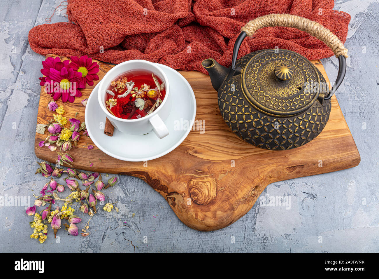 Herbal tea with flowers roses in cast-iron teapot. Asian style. Stock Photo